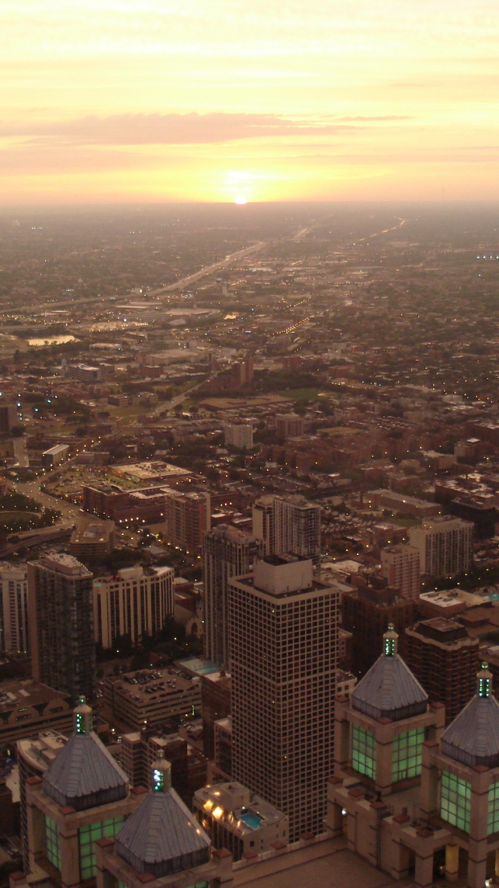 Обои городской пейзаж, дневное время, закат, небоскреб, городской район в разрешении 720x1280